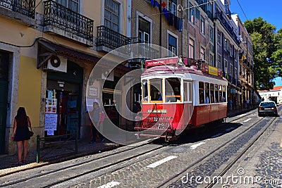 Red tram on a narrow street in Lisbon, Portugal Editorial Stock Photo